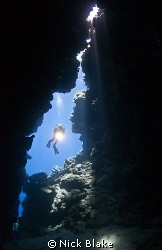 Shot of diver at entrance to cave. Taken at Jackfish Alle... by Nick Blake 